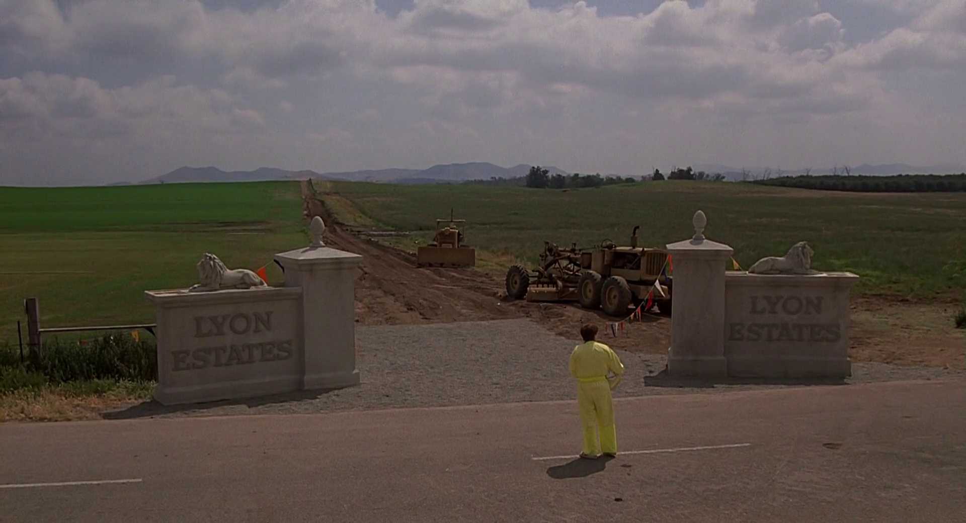 What is The Hollywood Model (aka "Berettermodellen")? Definition & Examples 8 A teenager in a yellow suit stands before a dirt road and construction equipment where a housing development sign reads “Lyon Estates”