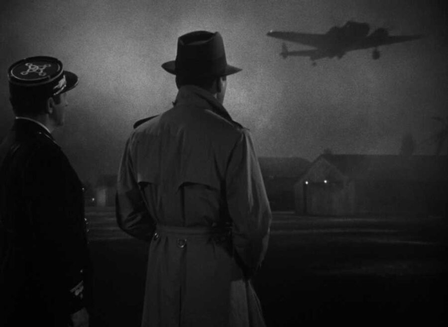 What is The Hollywood Model (aka "Berettermodellen")? Definition & Examples 11 Two men in trench coats watch a plane take off in the fog at night