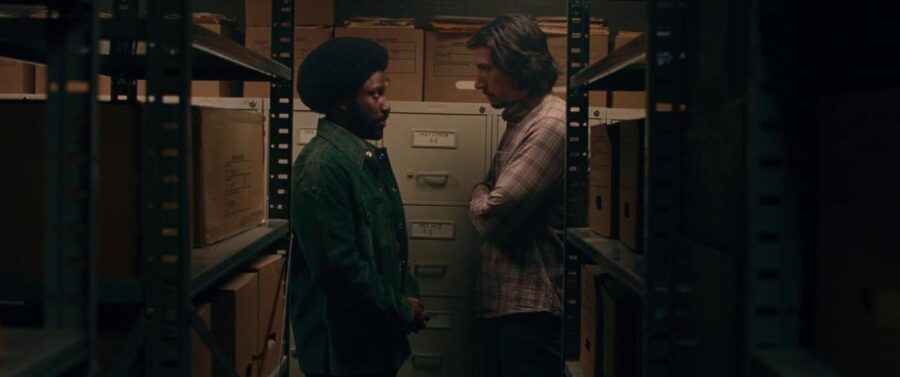 What is The Hollywood Model (aka "Berettermodellen")? Definition & Examples 7 Two men stand face-to-face in a narrow records room, surrounded by boxes and filing cabinets