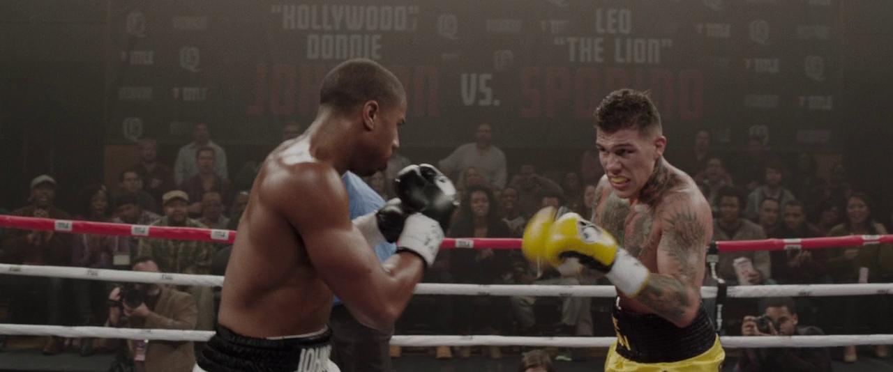 What is The Hollywood Model (aka "Berettermodellen")? Definition & Examples 9 Two boxers face off in a crowded ring, fists raised and tension high during a match
