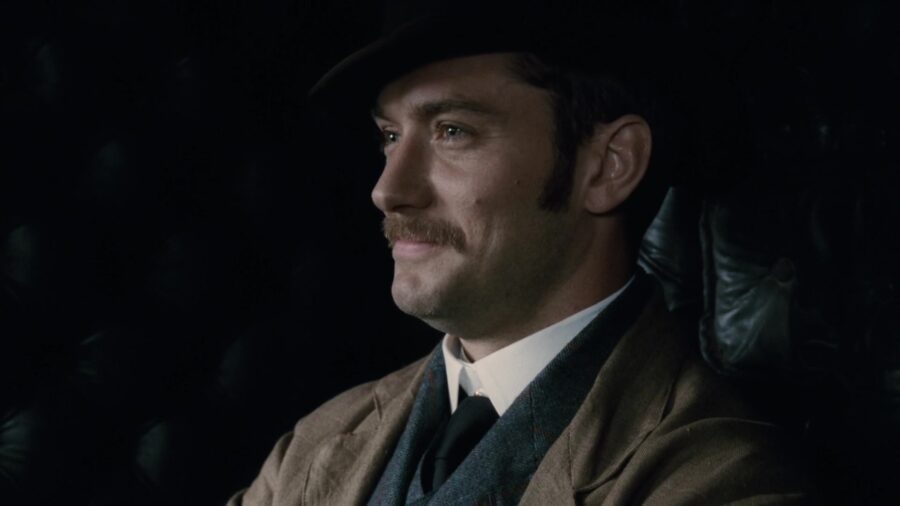 What Are the Rhetorical Appeals? Definition + Ethos, Pathos, Logos in Film & Ads 4 Dr. Watson smiles while seated in Sherlock Holmes (2009).