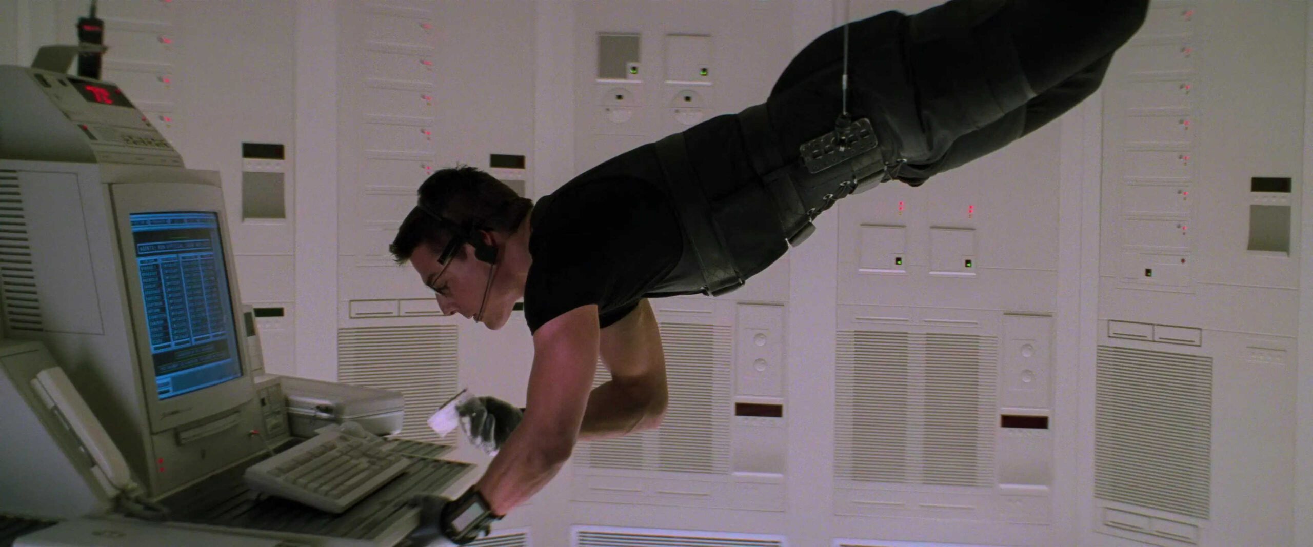 What Is A MacGuffin? Definition + Good & Bad Examples Explained 11 Ethan Hunt hangs suspended on a wire while stealing data from a computer in Mission: Impossible (1996).