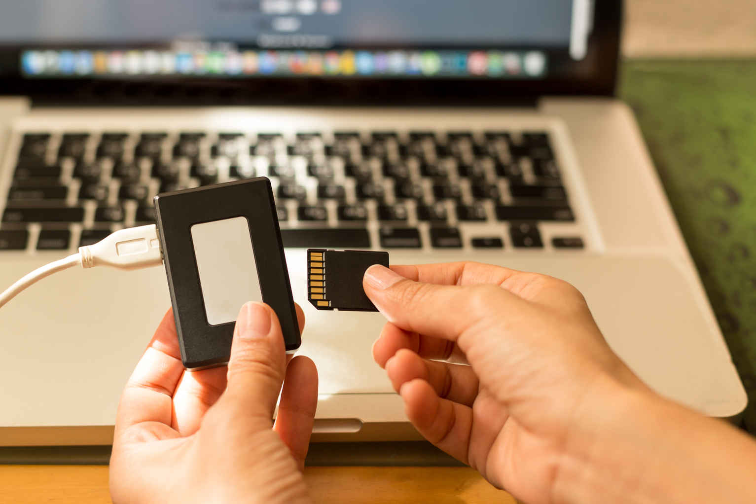 Low Budget Filmmaking Equipment List: What Do You Actually Need? 3 SD card and SD card reader in front of Macbook
