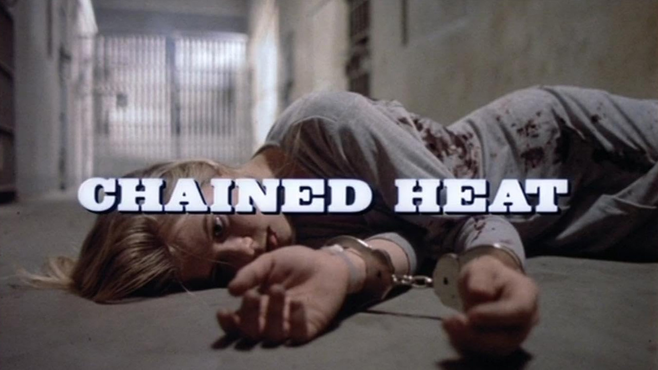 Sexy Female Prison Movies Too Taboo For Today's Audience 5 A woman lies on a prison floor in handcuffs with blood on her clothes in the opening of Chained Heat (1983)