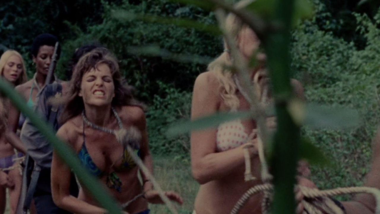 Sexy Female Prison Movies Too Taboo For Today's Audience 10 Women in bikinis are tied with rope and marched through the jungle by guards in The Hot Box (1972)