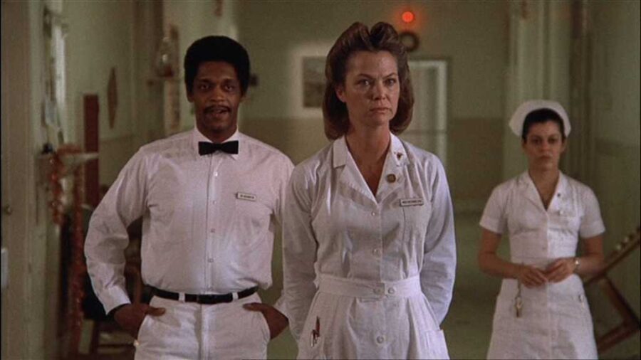 What Is an Antagonist? Meaning, Role & Film Examples 4 Nurse Ratched watches calmly in a clinical setting, projecting control.