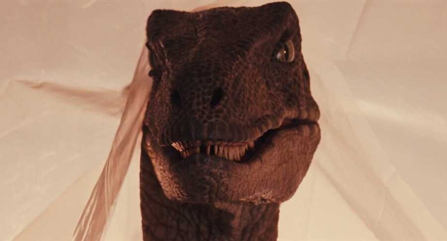 What Is an Antagonist? Meaning, Role & Film Examples 13 A dinosaur looms as humans react in fear, signaling a survival threat.