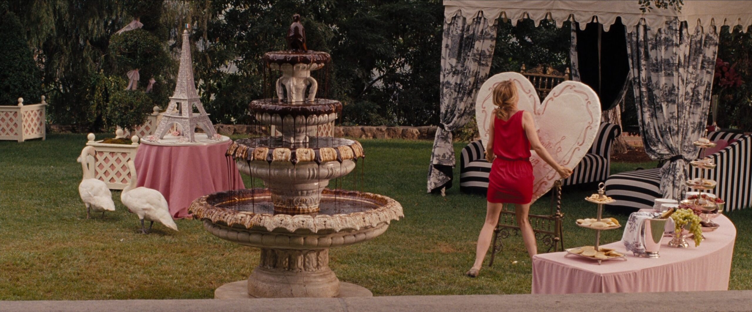 Climax in Film. Definition and Examples From Famous Movies. 5 Annie in a red dress slams a giant heart cookie at an extravagant garden bridal shower