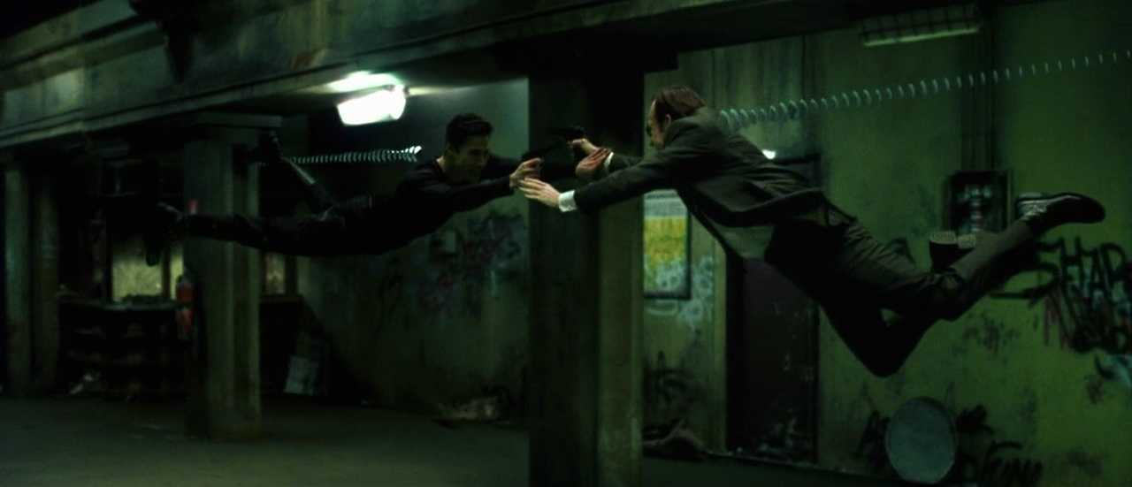 What is Campbell's Monomyth? A Hero Guide for Filmmakers 14 Neo and Agent Smith leap mid-air in a narrow hallway, firing at each other in slow motion with muzzle flashes and bullet trails.