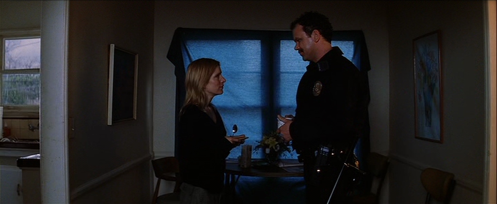 What is a Narrative in Film? Meaning, Definition & Structure Examples. 13 A uniformed police officer talks with a blonde woman in a dim apartment hallway, with a blue-covered window behind them.