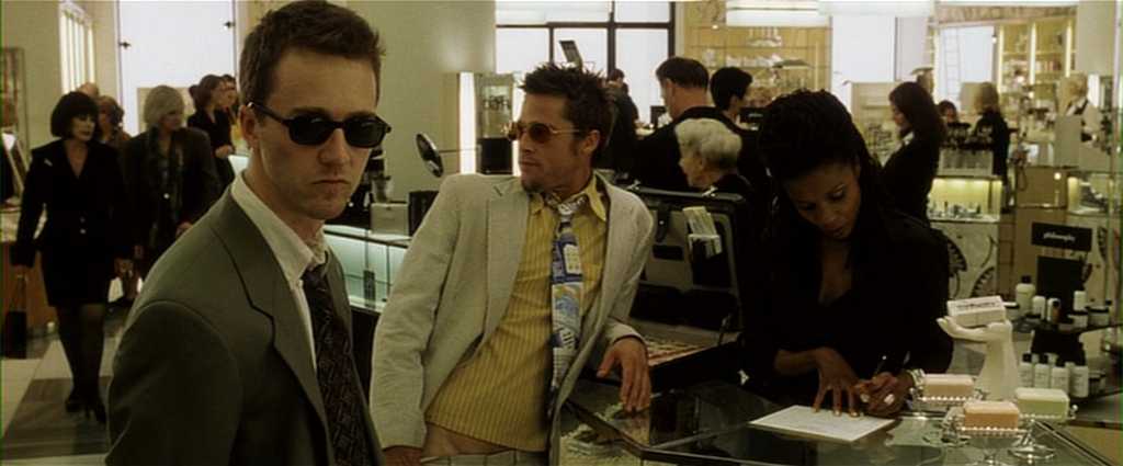 What is a Narrative in Film? Meaning, Definition & Structure Examples. 15 Two men wearing sunglasses stand at a department store counter near a jewelry display while a saleswoman looks down and writes on a form.