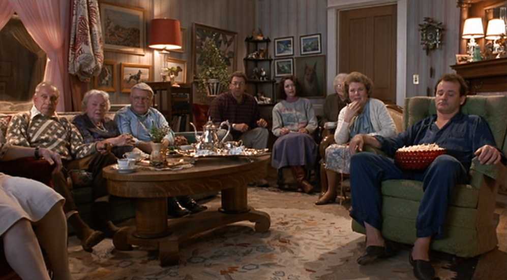 What is a Narrative in Film? Meaning, Definition & Structure Examples. 8 A group of hotel guests sit in a cozy living room watching TV while a man in a chair on the right holds a bowl of popcorn.