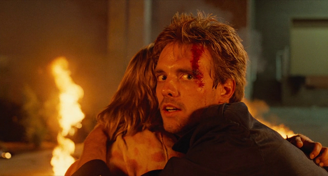 Paradox in Film: Definition, Types, and Movie Examples 6 Kyle Reese, bleeding and wide-eyed, hugs Sarah Connor in front of flames after a violent battle.