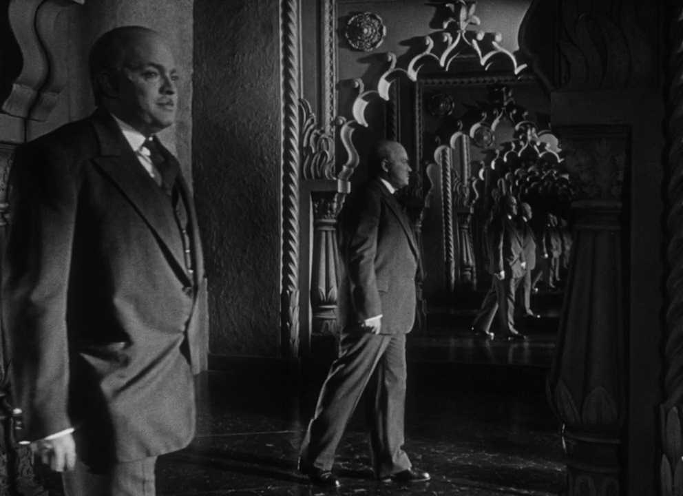 What is Hamartia? Definition & Examples From Literature & Film 2 Charles Foster Kane in a suit stands in an ornate corridor of mirrors, his reflections repeating into the distance.