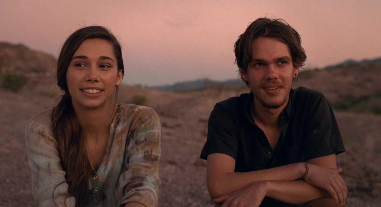 What is a Narrative in Film? Meaning, Definition & Structure Examples. 10 Two young adults sit outdoors in a desert landscape at dusk, looking off to the side as they talk.