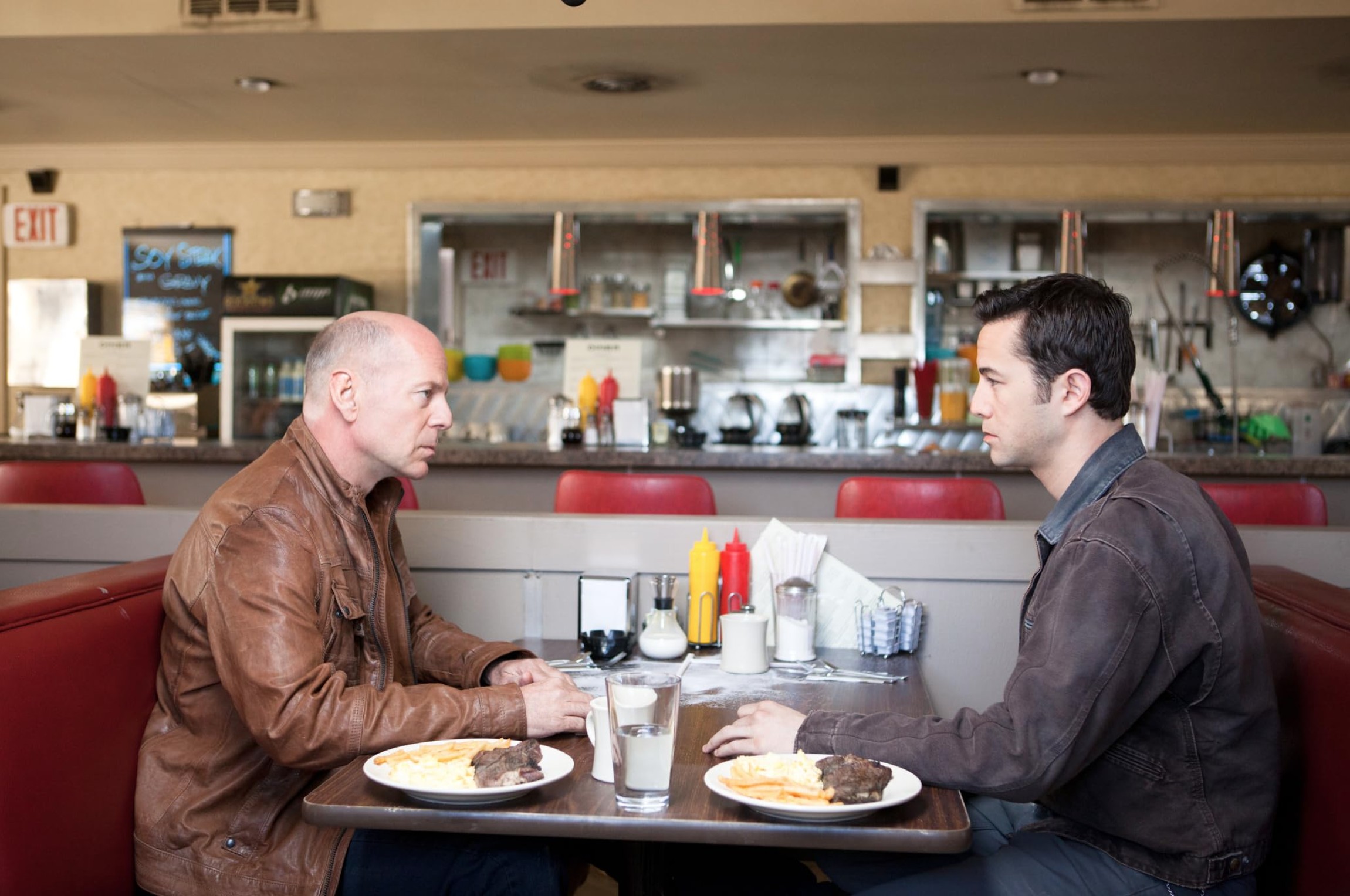 Paradox in Film: Definition, Types, and Movie Examples 5 A young man and his older self sit face-to-face in a diner booth, identical meals on the table between them.