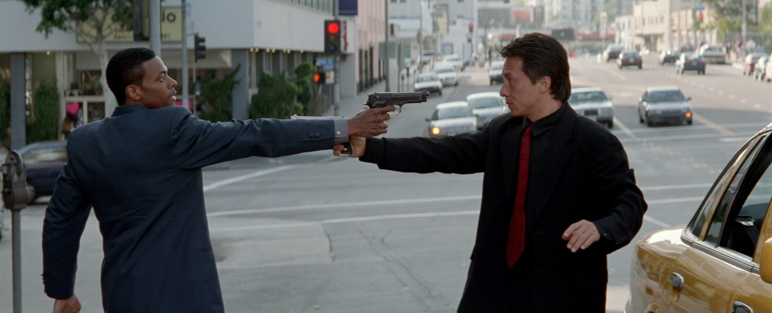 Oxymoron Definition: Examples in Film and Literature 3 Two men point guns at each other on a Los Angeles street, standing still in front of a line of cars