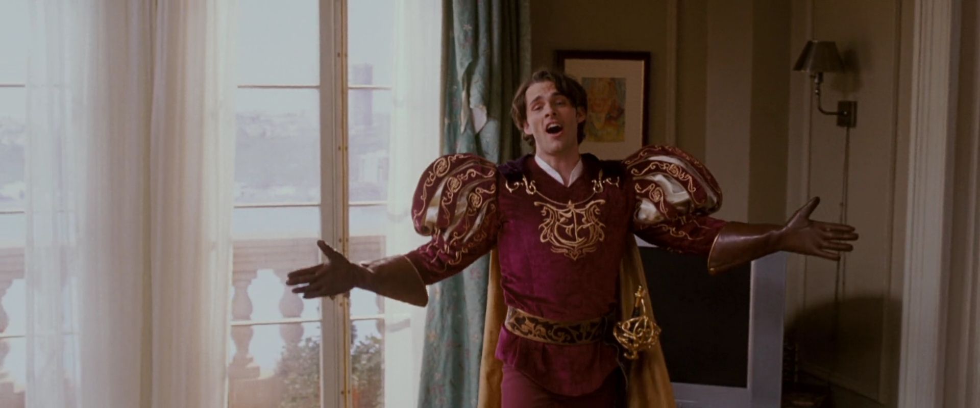 Persona in Movies. Meaning, Definition & Examples. 3 Prince Edward in a puffed royal costume, arms spread wide as he sings dramatically inside a New York apartment