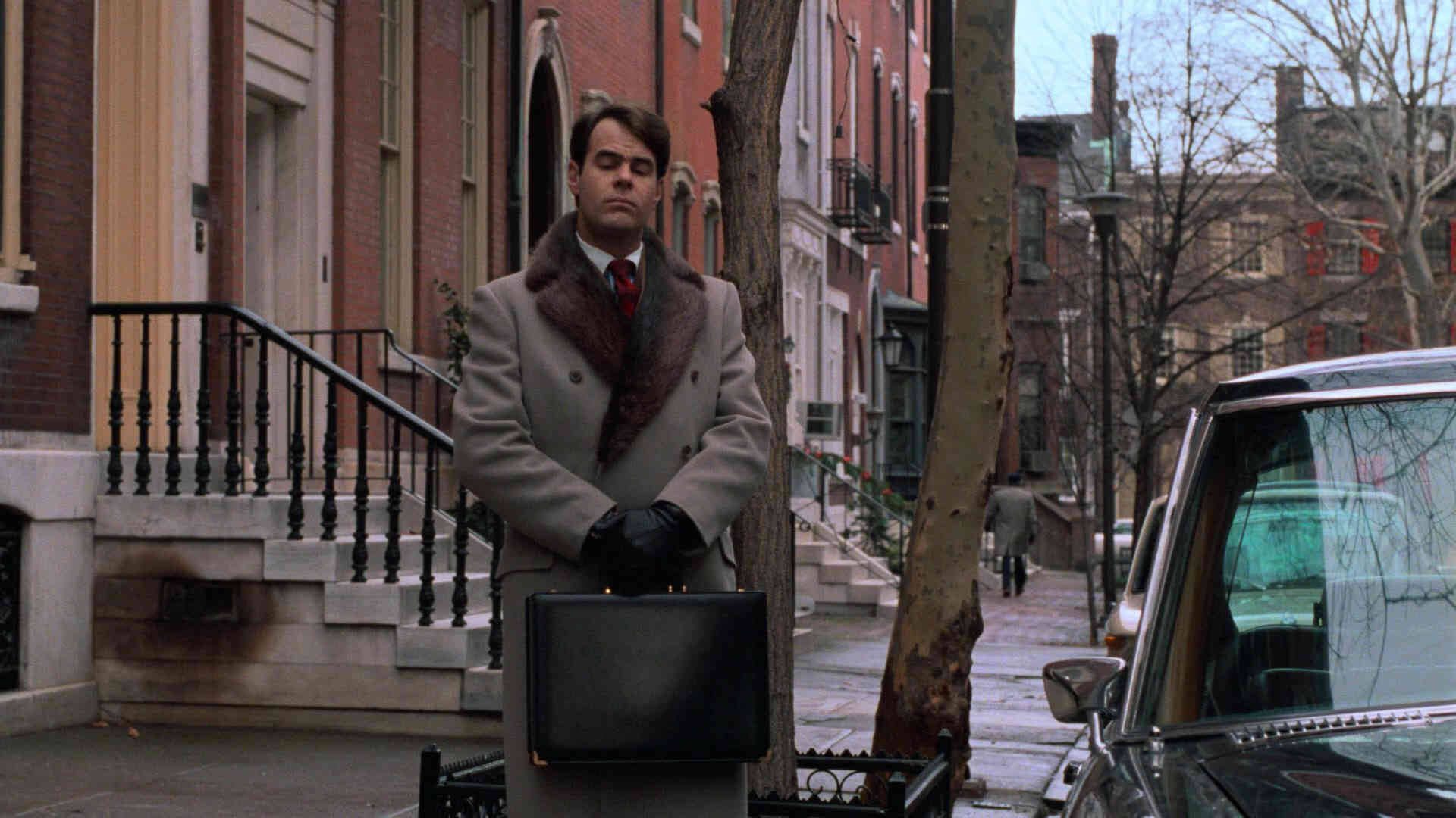 Peripeteia in Film. Definition, Meaning & Examples 2 Louis Winthorpe III stands on a quiet city street with a briefcase beside parked cars and brick row houses.