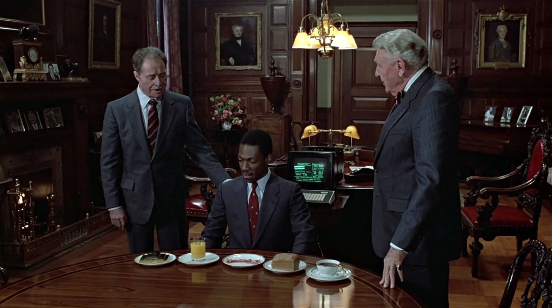 Peripeteia in Film. Definition, Meaning & Examples 7 Billy Ray Valentine sits at a table with breakfast in a wood-paneled office while two older businessmen stand close by.
