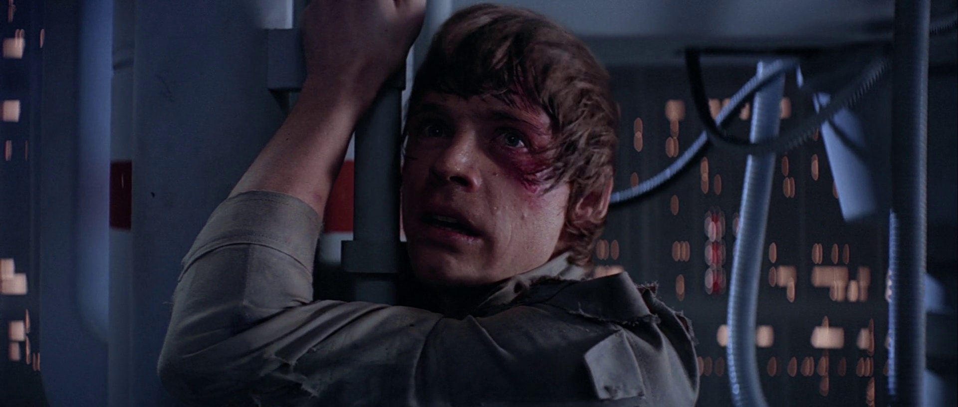 What is Anagnorisis? Definition & Examples from Film 2 Luke Skywalker clings to a railing, bruised and shocked, in a dim, high-tech setting.