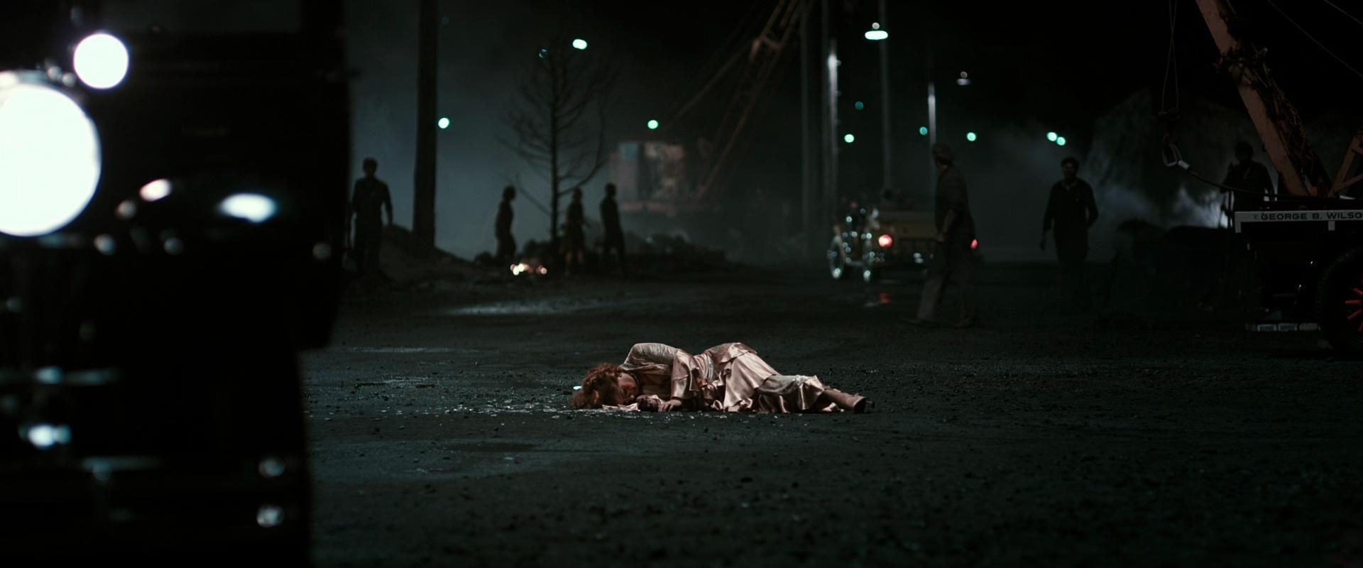 What is Anagnorisis? Definition & Examples from Film 5 Gatsby’s body lies in the road after being shot, with figures standing in the background.
Caption:
