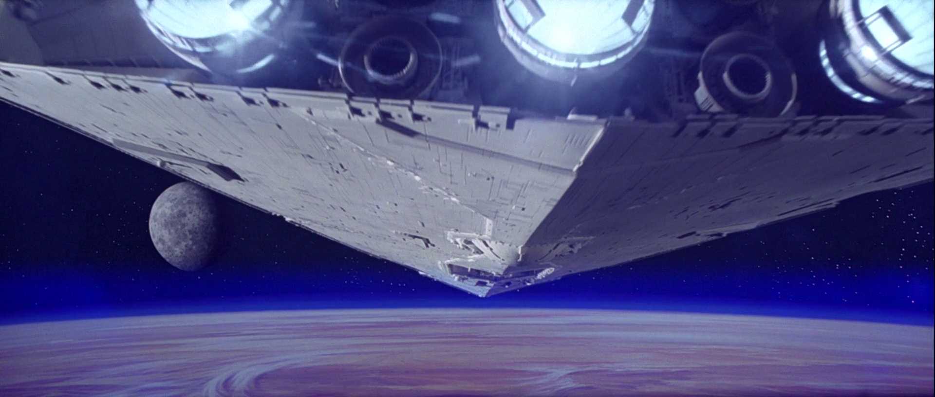 What is Escapism? How Films Make Us Forget Ourselves 4 Star Destroyer flies over a desert planet in space in the opening shot of Star Wars: A New Hope