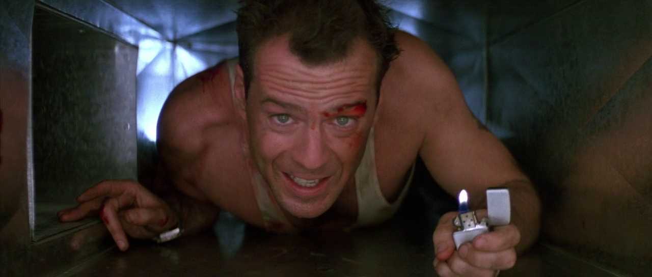 What is a Hero? Definition & Film Examples 3 John McClane crawling through a metal air duct holding a lighter, with a bruised face and torn undershirt