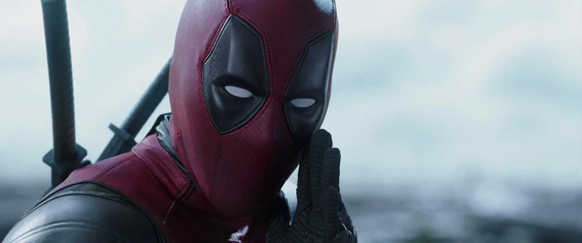 What is a Hero? Definition & Film Examples 4 Deadpool in his red and black suit holding a hand to his mouth in a mocking or surprised gesture
