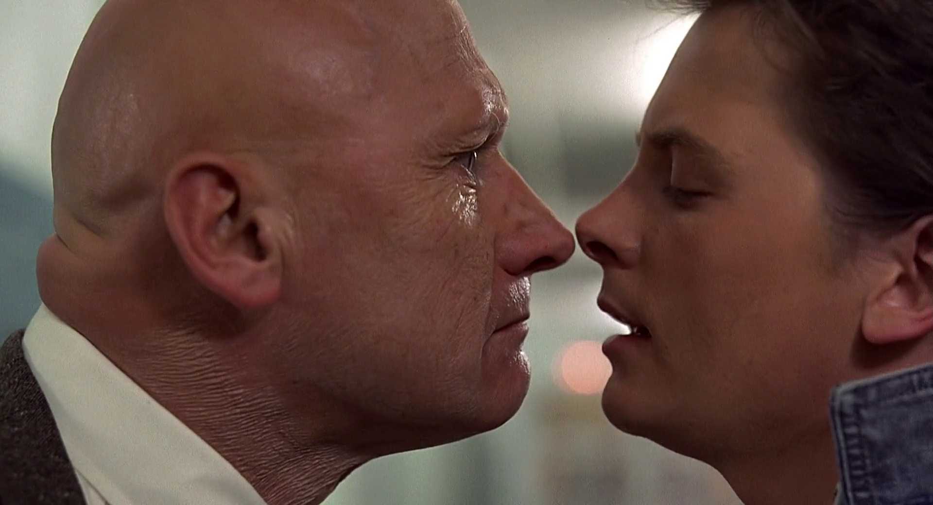 What is a Flat Character? Definition & Examples from Film 4 Principal Strickland leans in close to Marty McFly, their faces nearly touching in a tense confrontation.