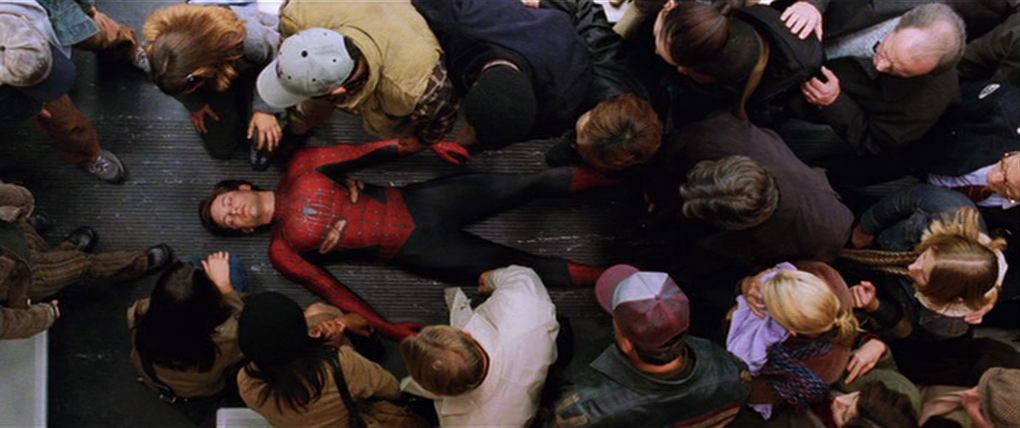 What is Characterization? Elements Defining Your Characters 6 An overhead view shows Spider-Man lying on the floor of a train car while a crowd of passengers leans in around him.