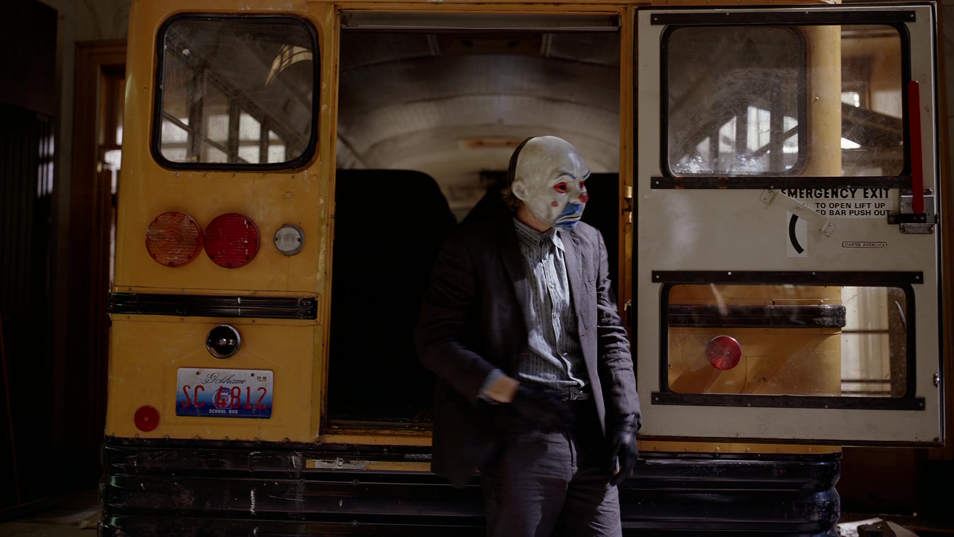What is Characterization? Elements Defining Your Characters 3 The Joker wears a white-and-blue clown mask and dark suit as he steps out of the back of a yellow school bus inside a garage-like space.