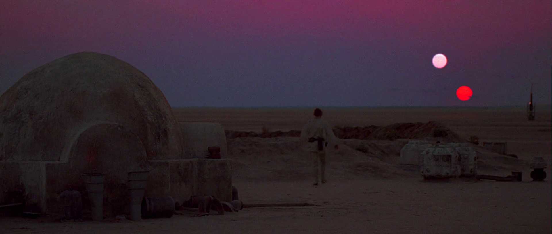 Film Theory: Definition, Discourses, and How to Use It 17 A figure stands on a desert landscape, looking at two suns setting in the sky in Star Wars