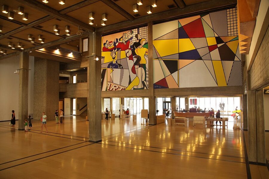 What Is Pop Art? Definition & Film Influence 3 Roy Lichtenstein mural with comic-style figures and geometric patterns in the Tel Aviv Museum of Art.