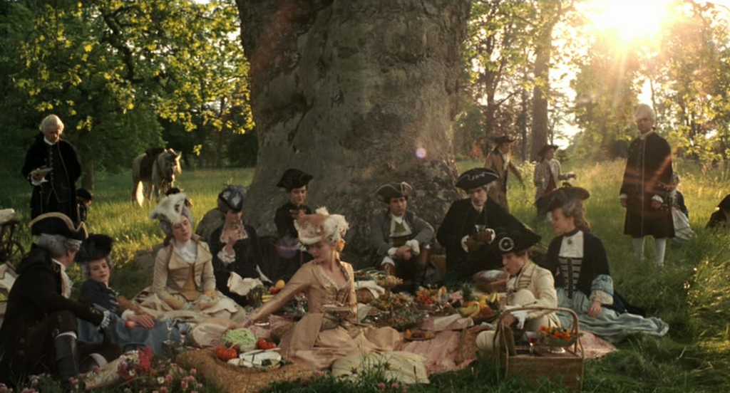 What Is Rococo Art? Definition, Style, and Legacy 14 Group of aristocrats in powdered wigs and gowns picnicking under a tree in soft golden light