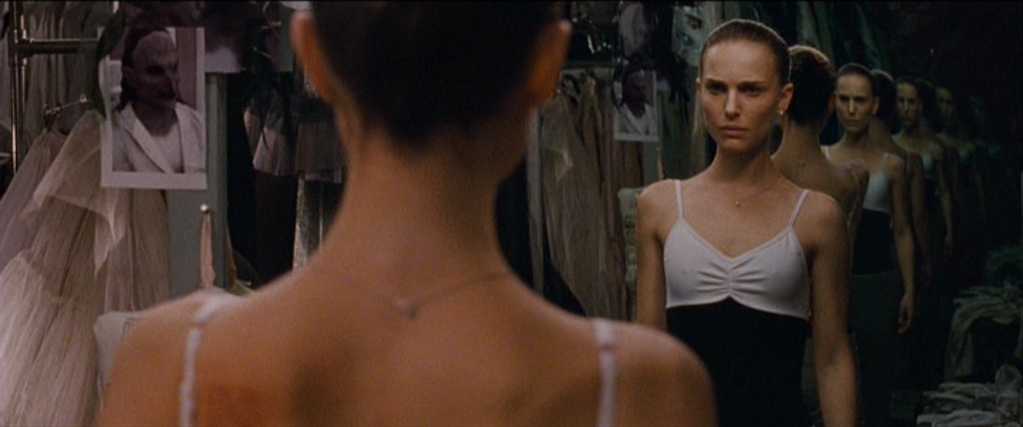 What Is a Thriller Movie? Definition, Traits & Classic Examples 6 A ballerina stands in front of a mirror showing multiple reflections, creating a disorienting visual effect.
