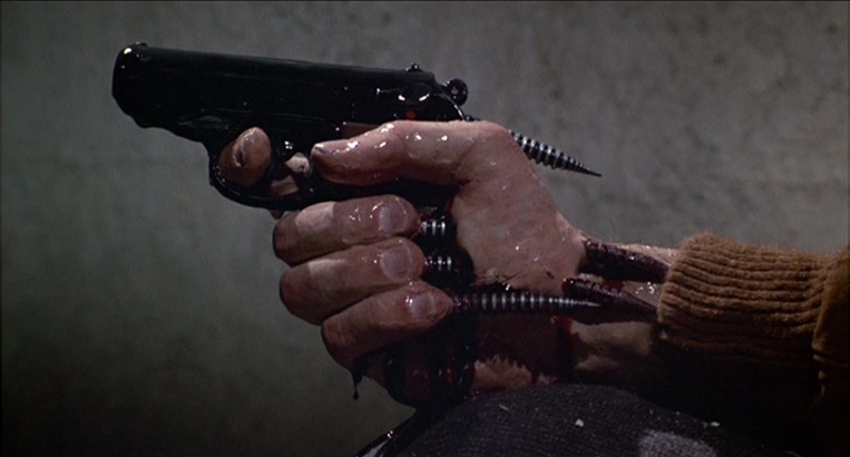 What Is a Horror Movie? Definition, Subgenres & Examples 5 Mutated hand holding gun with spikes pushing through fingers
