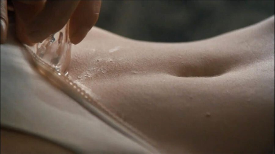 What Is Erotic Cinema? Definition, Genre & Global Examples 7 A close-up of a hand moving a glass object across bare skin in 9½ Weeks (1986, MGM)