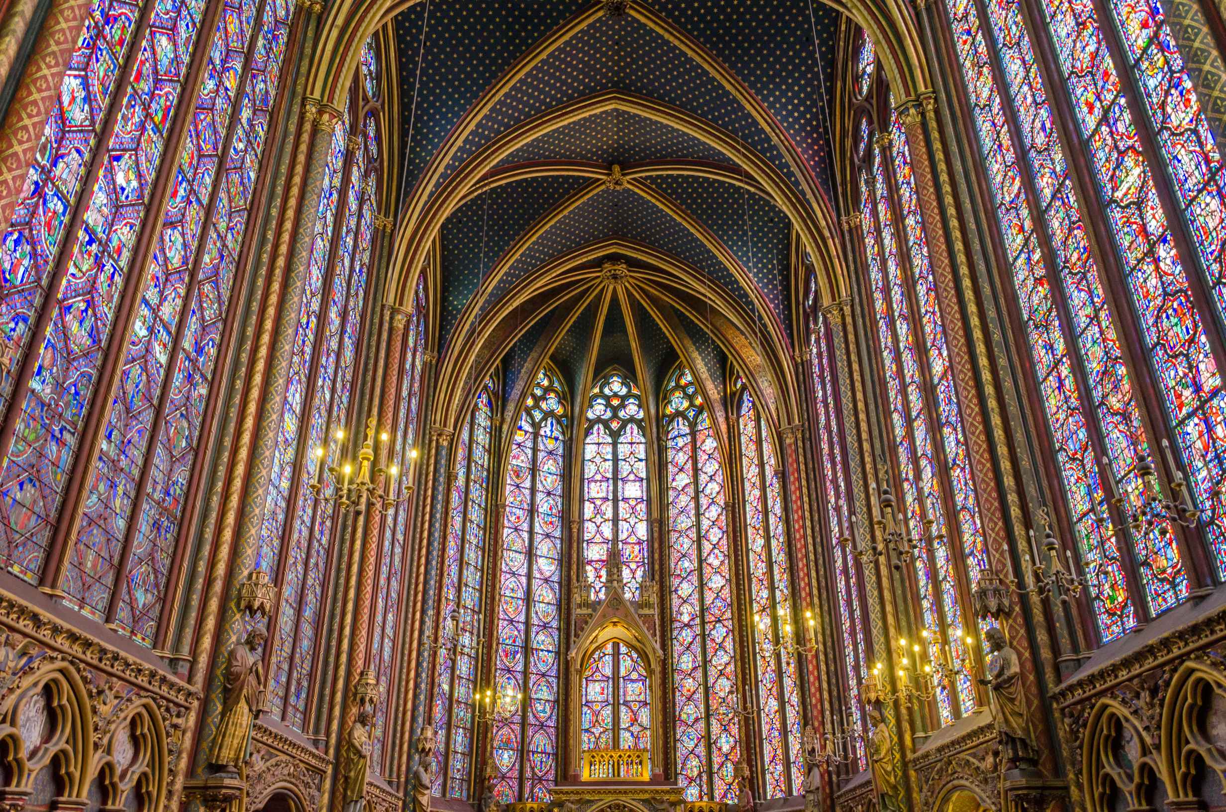 What Is Gothic Art? Definition, History & Examples 6 nterior of Sainte-Chapelle with tall stained-glass windows in vibrant jewel tones