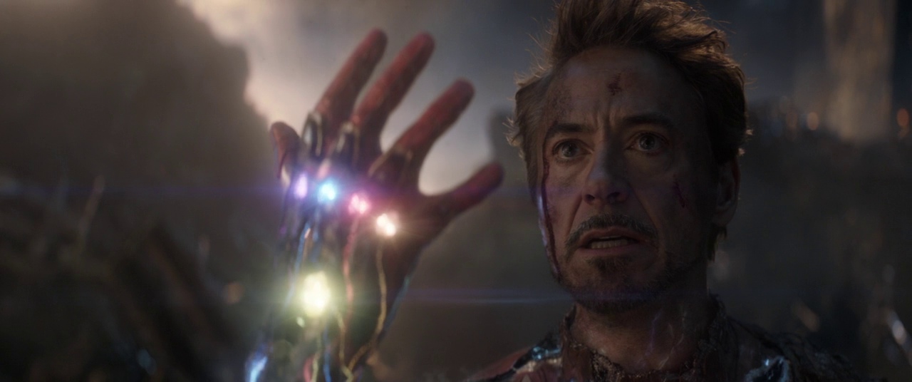 What Is a Movie Spoiler? Full Breakdown with Examples 4 Tony Stark raises his hand with the Infinity Stones glowing in Avengers: Endgame.