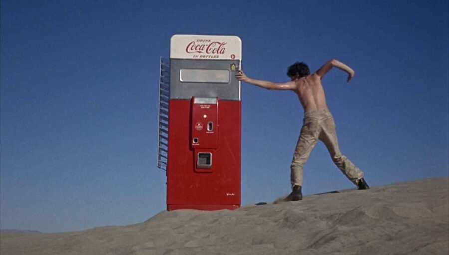 What Is Pop Art? Definition & Film Influence 5 Man posing beside Coca-Cola machine in desert scene from Head (1968, Columbia Pictures).