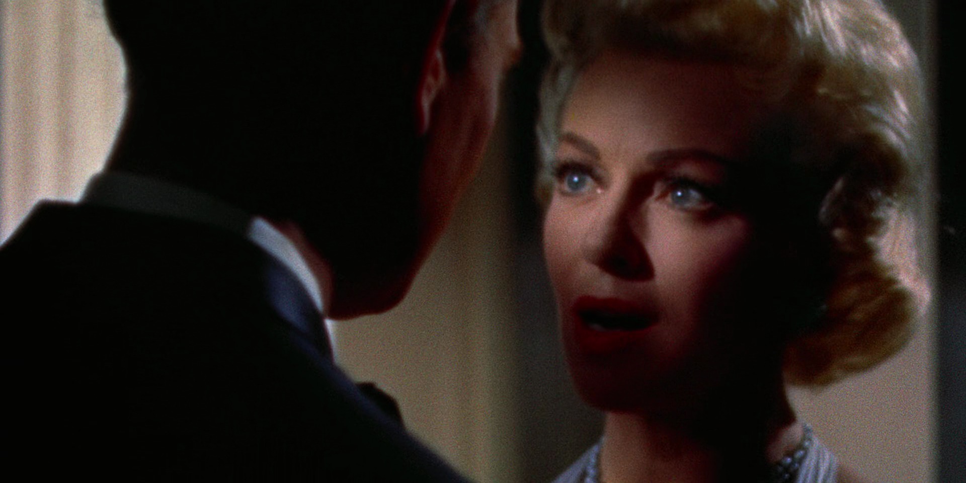 What Is Drama? Definition, Subgenres, and Themes 2 Close-up of a woman speaking emotionally to a man whose face is in shadow in Imitation of Life (1959)