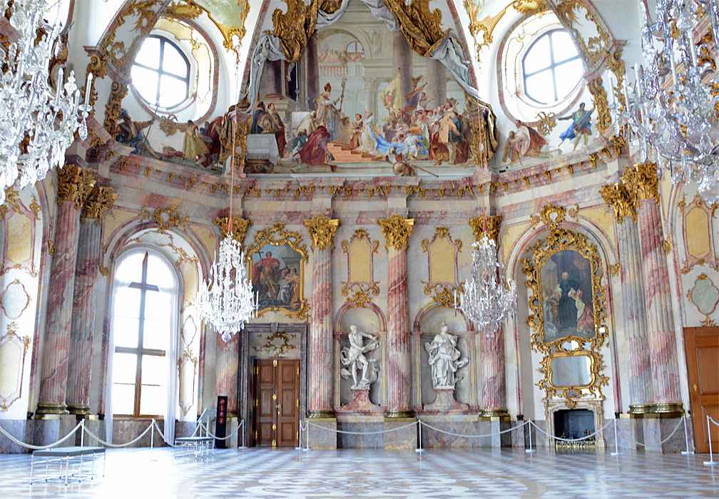 What Is Rococo Art? Definition, Style, and Legacy 2 Interior of the Kaisersaal at the Würzburg Residence with pink marble columns, gold ornamentation, chandeliers, and frescoed ceiling