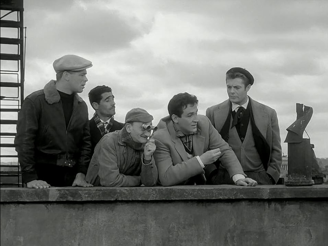 What Is Commedia all’italiana? Definition & Film Style 2 Five men stand on a rooftop planning a heist in Big Deal on Madonna Street (1958)