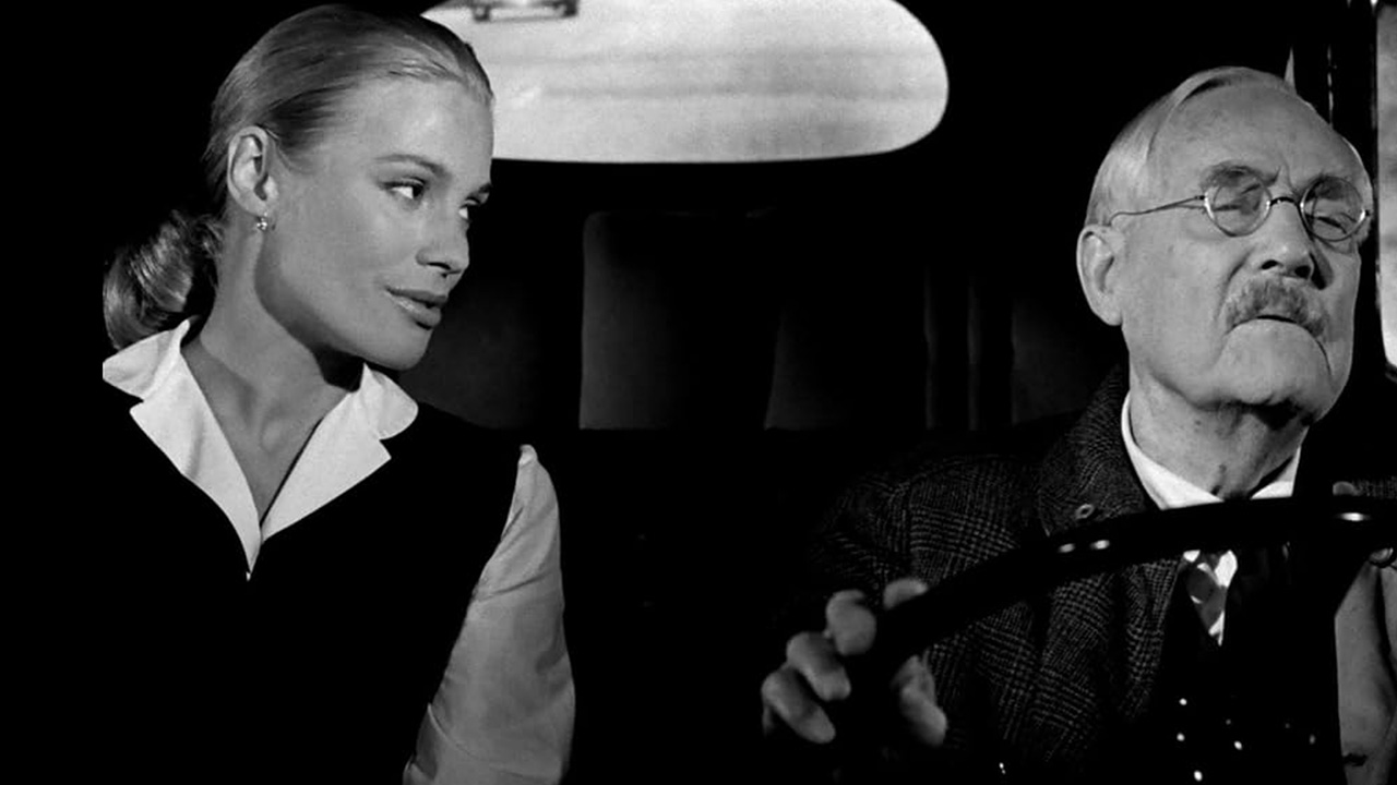 What Is Drama? Definition, Subgenres, and Themes 7 Older man driving a car while a younger woman looks at him in a scene from Wild Strawberries (1957)