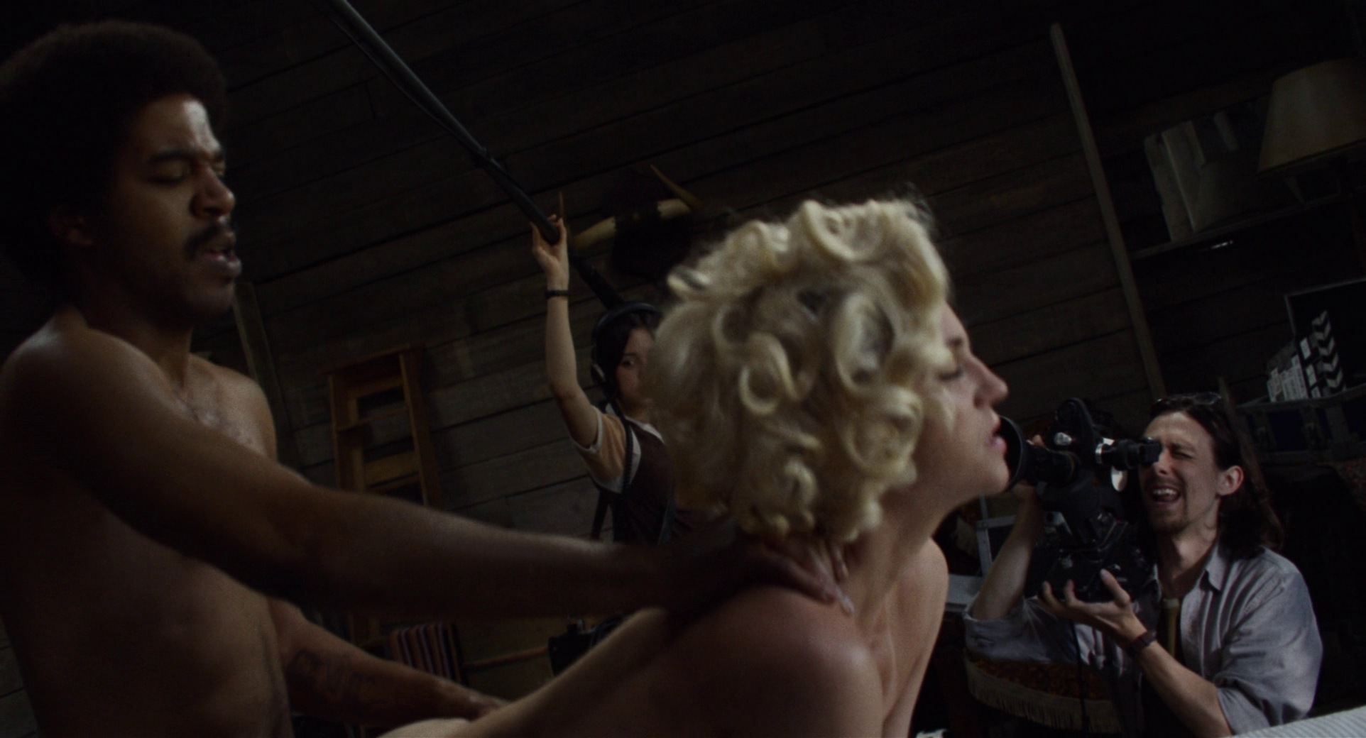 What Is a Slasher Movie? The Horror Genre Explained 2 Porn scene being filmed in rustic cabin with crew and camera operator
