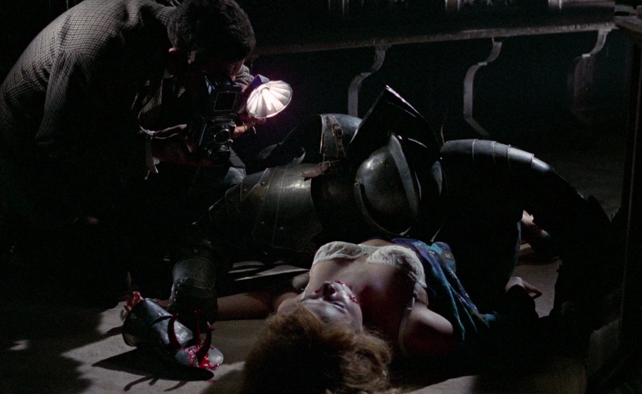What Are Giallo Films? Definition, History & Key Examples 6 Photographer examining a woman’s body next to a fallen suit of armor in a dark room in Blood and Black Lace (1964)