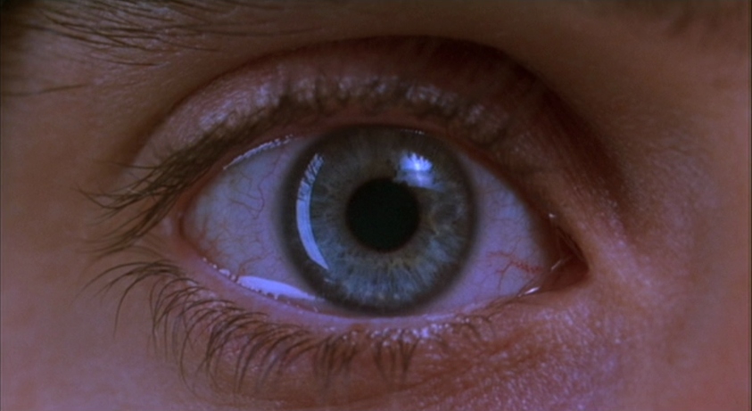 What Is Subjective Cinema? POV Filmmaking, VR, and Emotion 2 Extreme close-up of a dilated blue eye staring forward, reflecting light