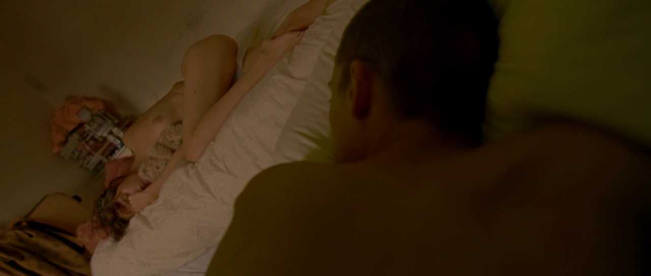 What Is an Arthouse Film? Definition, Examples & Style 2 Two characters lie in bed in a dark, tilted frame from Enter the Void (2009)