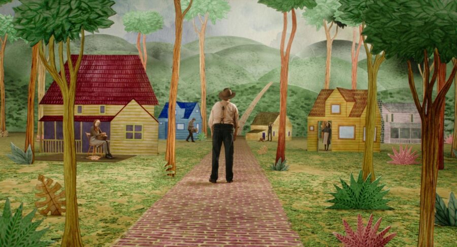 What Is an Arthouse Film? Definition, Examples & Style 6 A man stands on a painted road in a surreal village in Beau Is Afraid (2023)